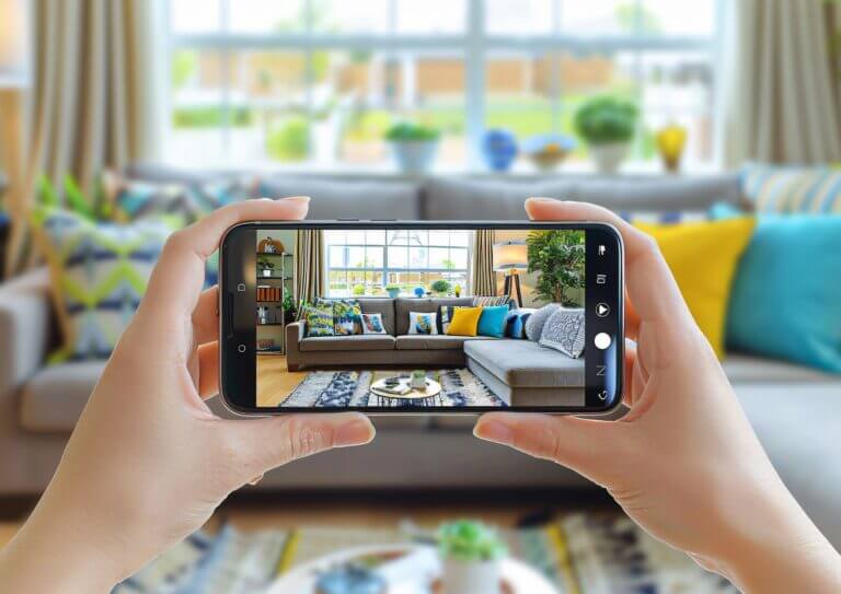 person-showcasing-their-home-through-smartphone